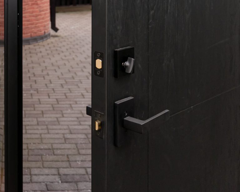 Open black MASTERGRAIN fiberglass door with woodgrain texture and modern hardware